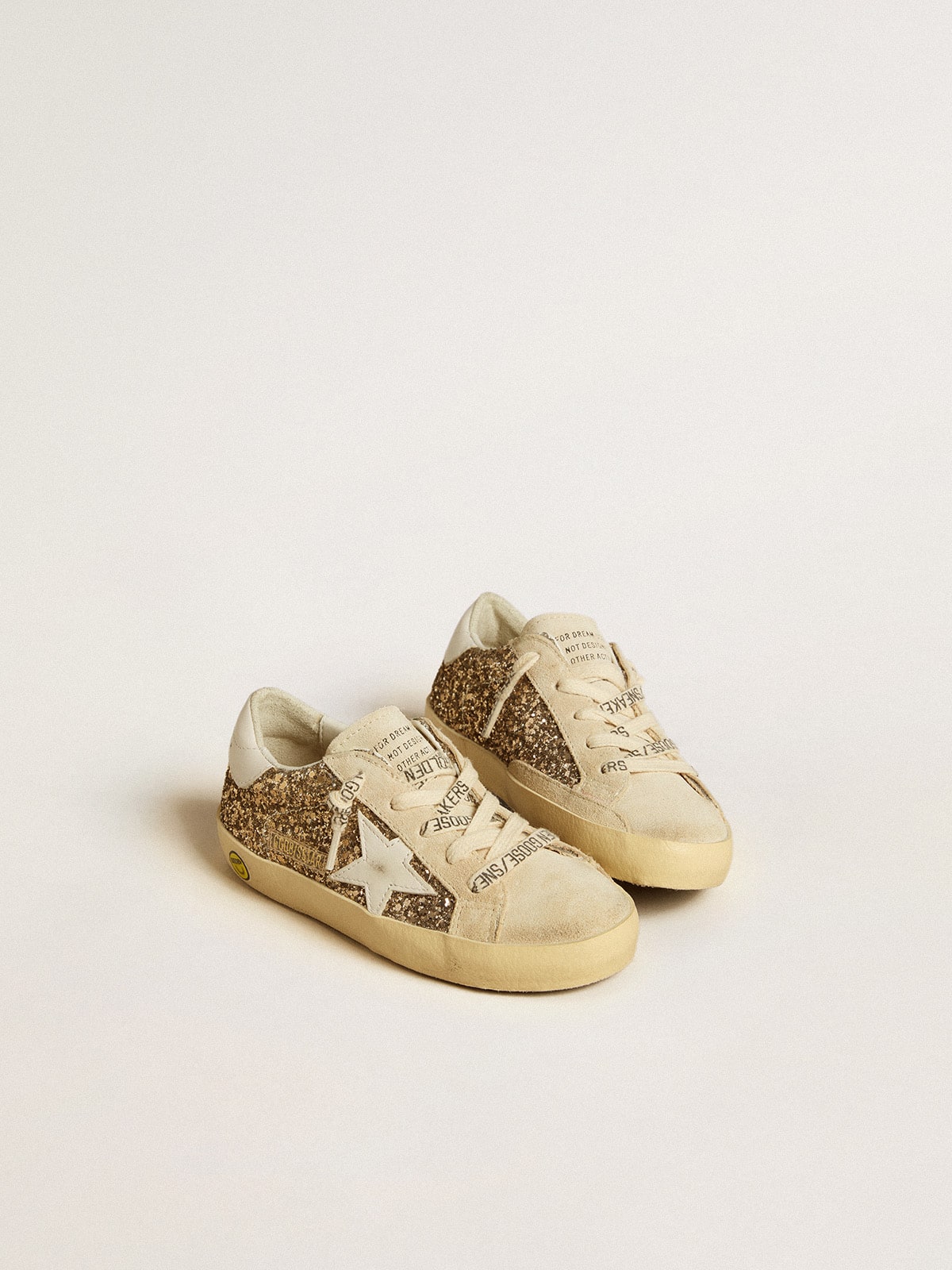 Super-Star Junior in gold glitter with white leather star and heel tab