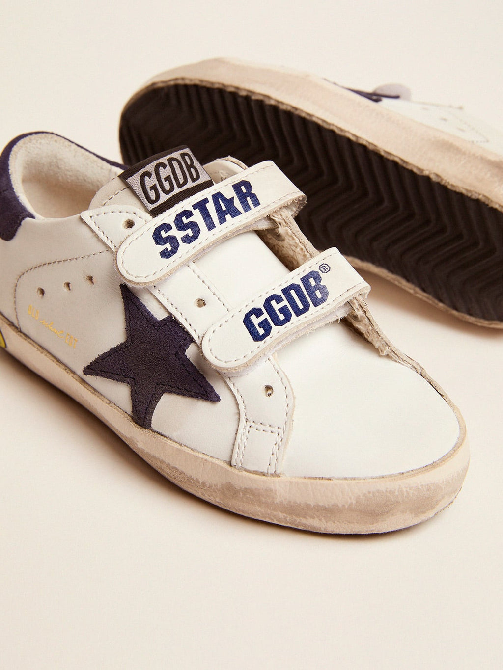 Old School Junior in white leather with blue suede star and heel tab