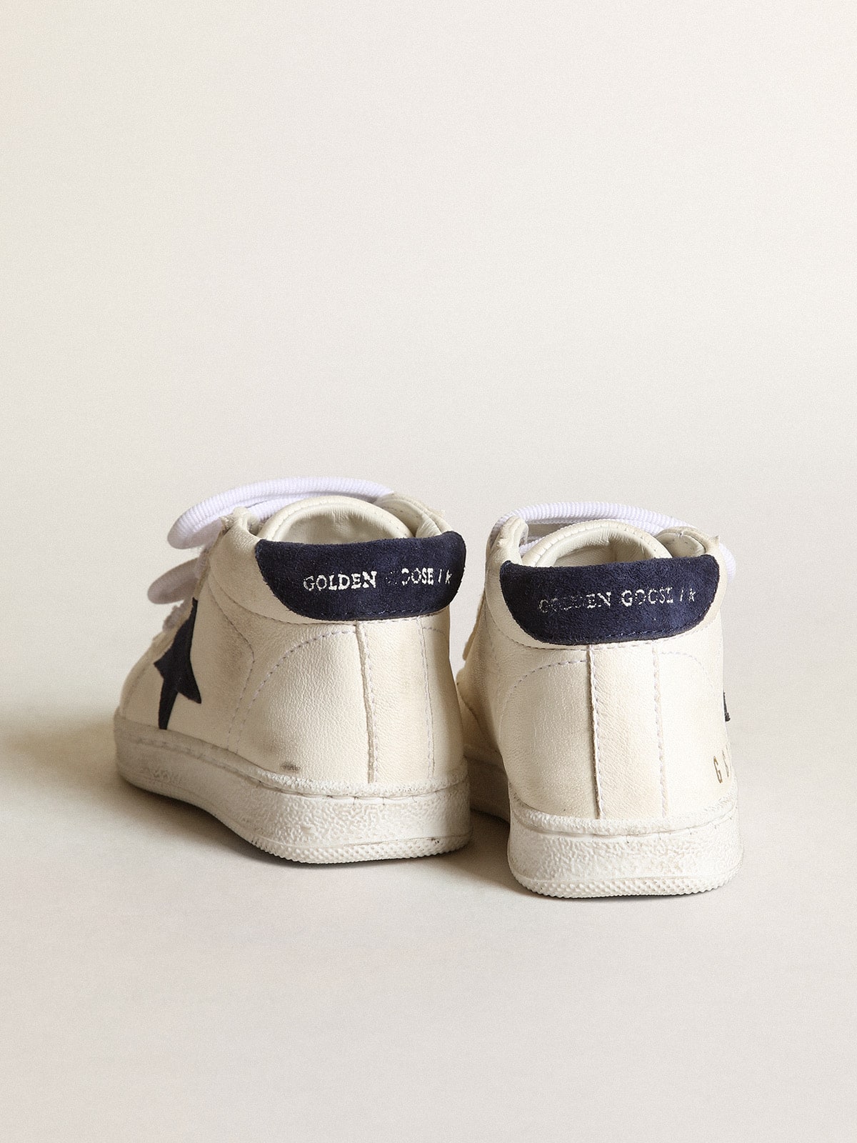 June Junior in nappa with dark blue suede star and heel tab