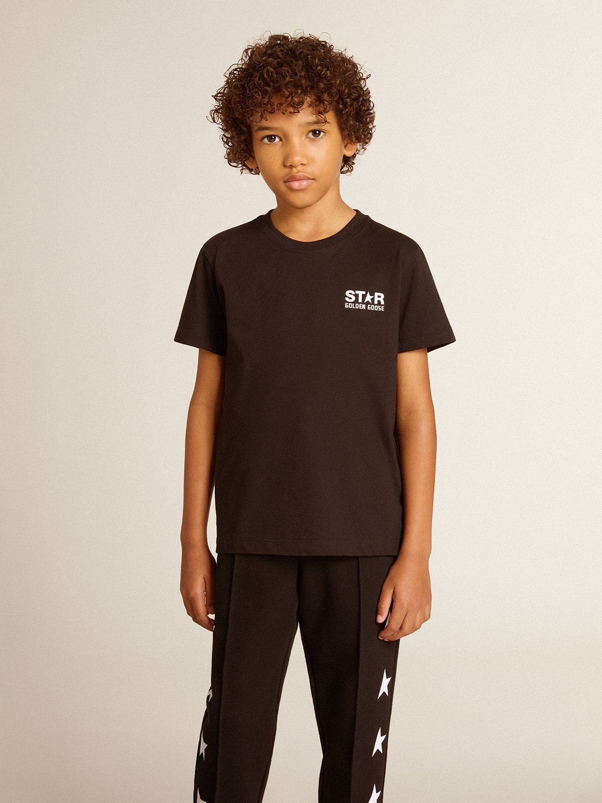 Black T-shirt with contrasting white logo on the front and maxi star on the back