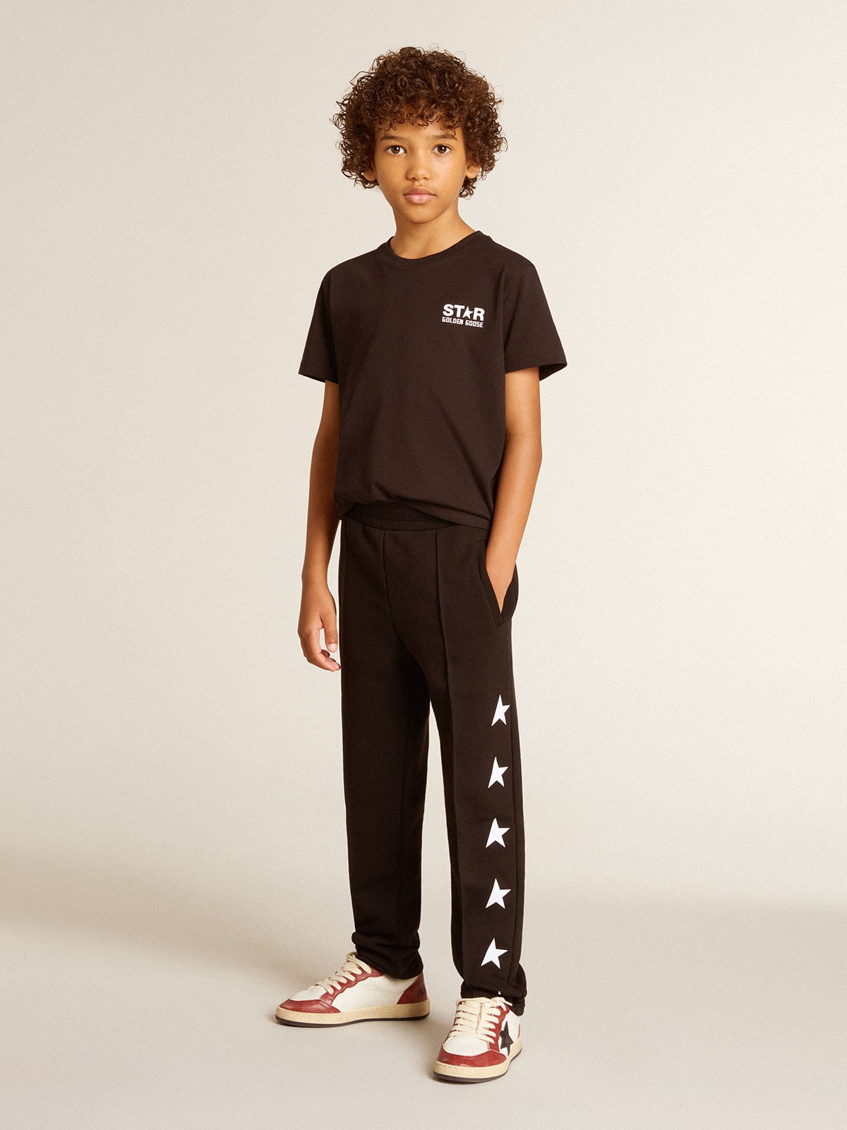 Black T-shirt with contrasting white logo on the front and maxi star on the back