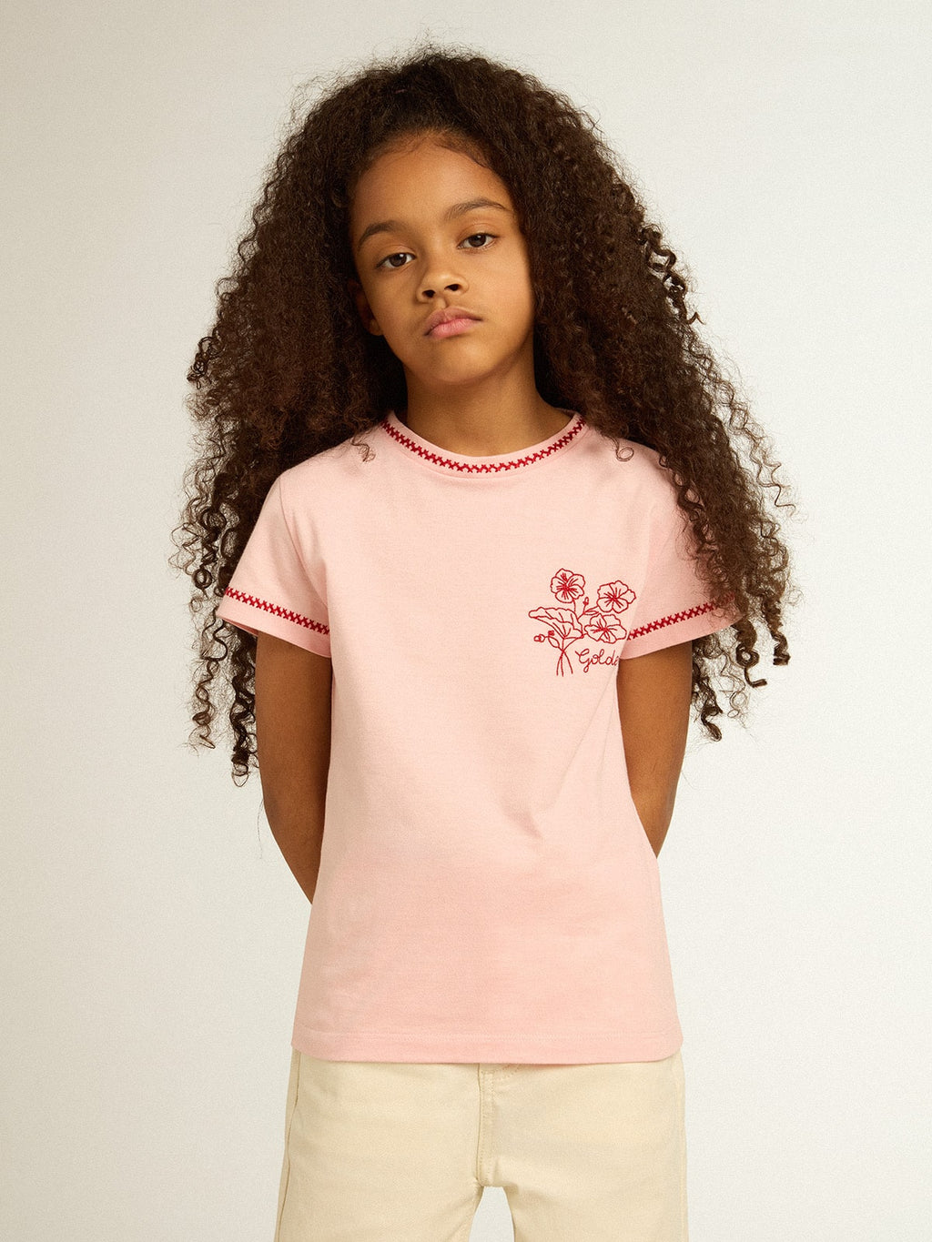 Pink T-shirt with red trim and embroidered flower on the heart