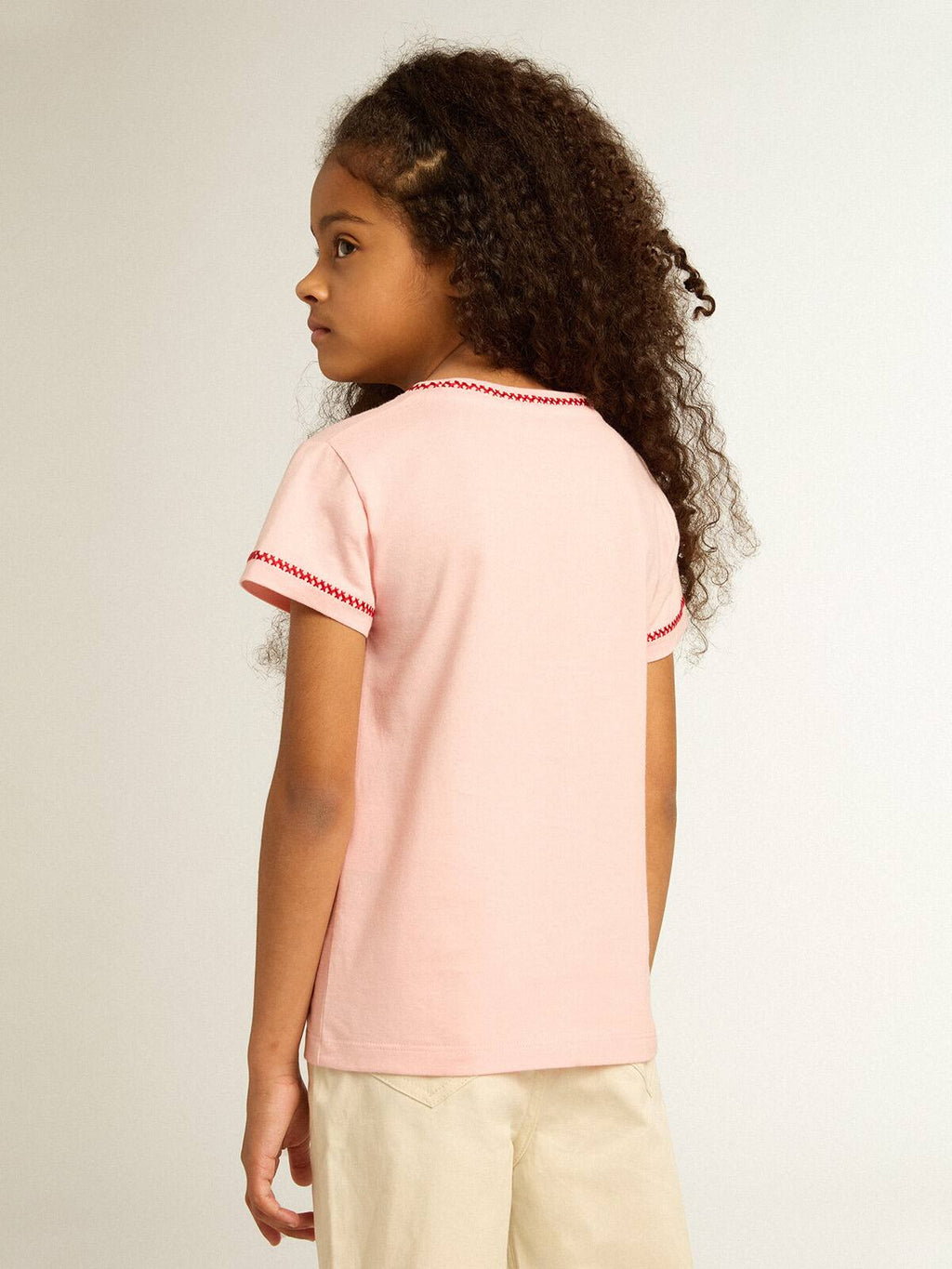 Pink T-shirt with red trim and embroidered flower on the heart