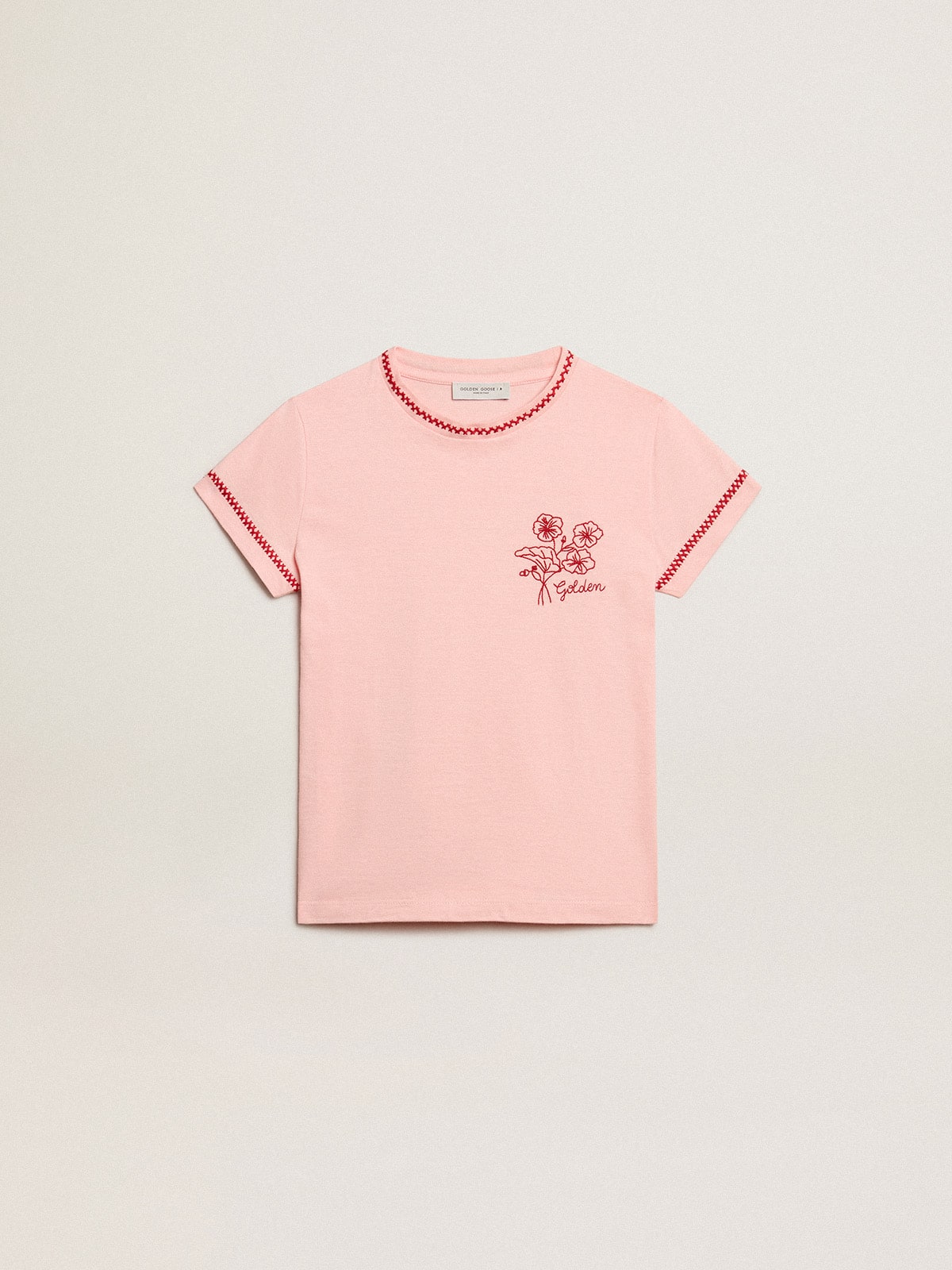 Pink T-shirt with red trim and embroidered flower on the heart