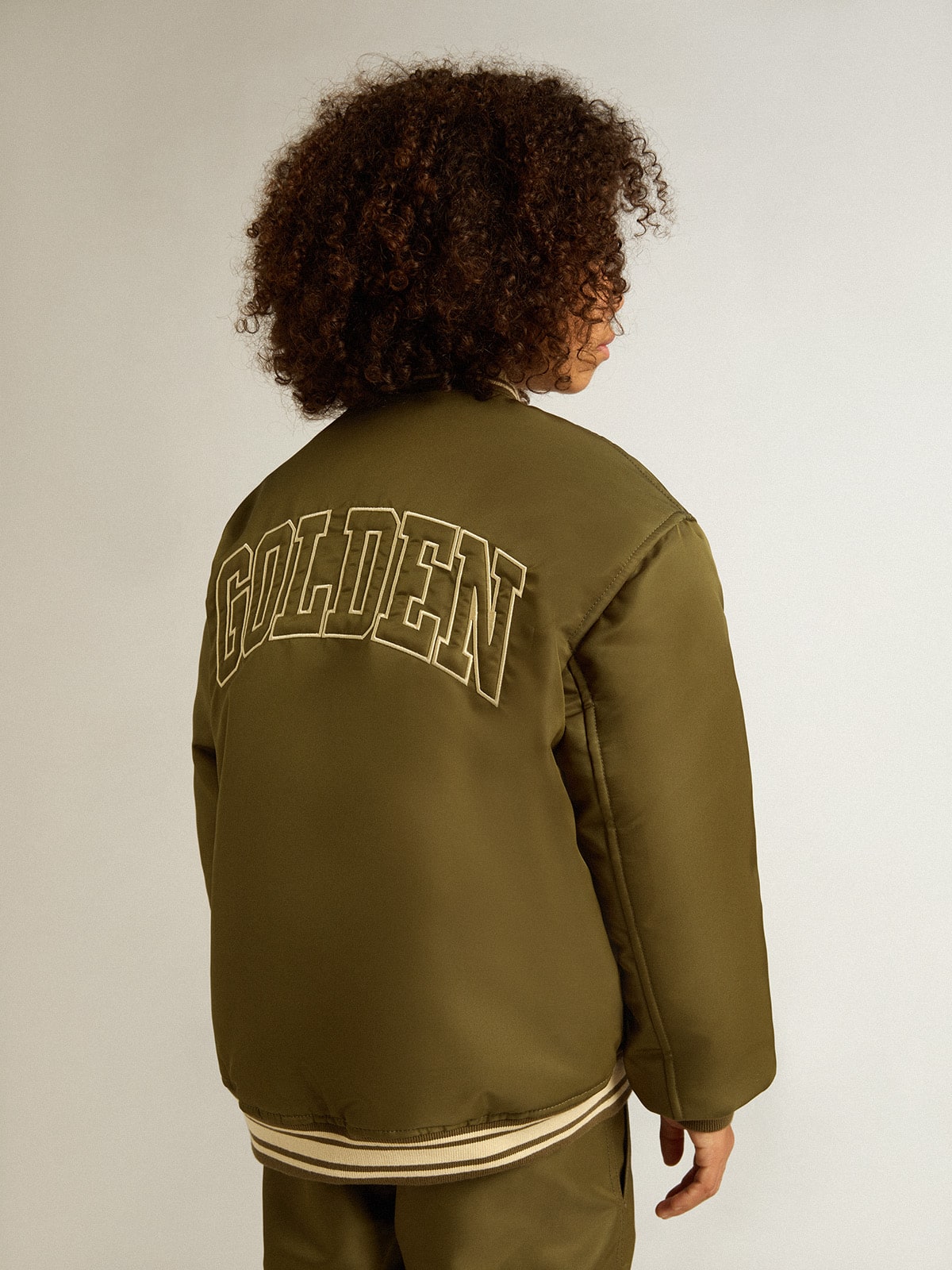 Kids military-green nylon bomber jacket with lettering on the back