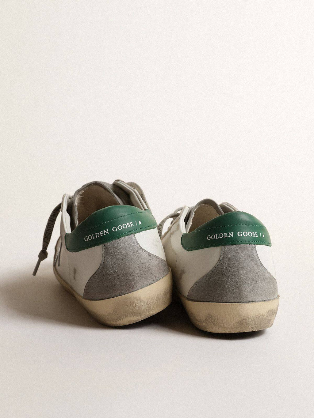 Men’s Super-Star in white leather with silver star and green heel tab
