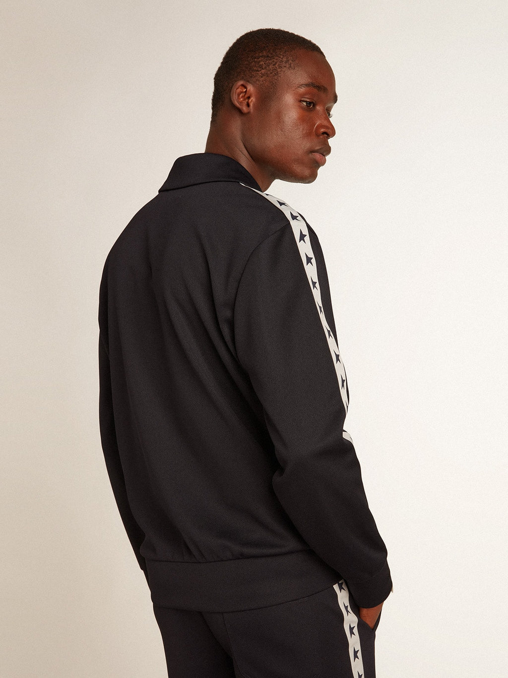 Dark blue sweatshirt with white strip and contrasting blue stars