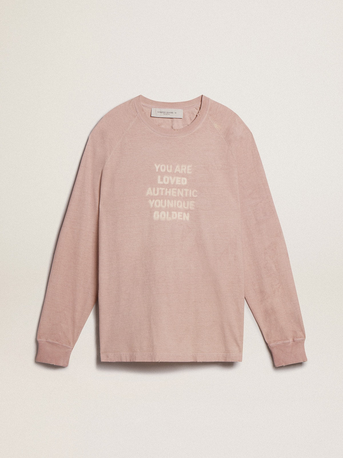 Powder-pink T-shirt with white lettering on the front
