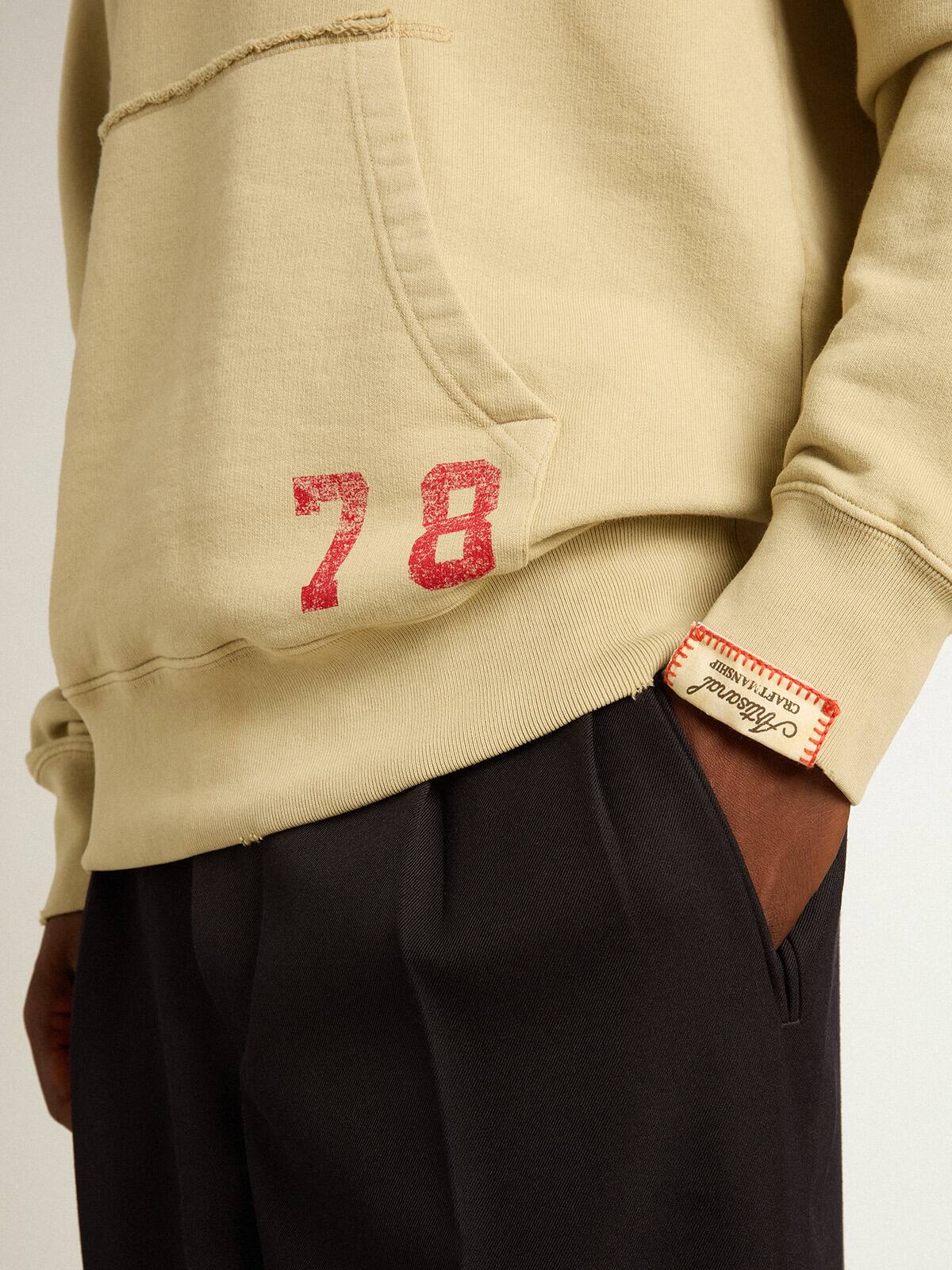 Pale eucalyptus-colored hoodie with front pocket