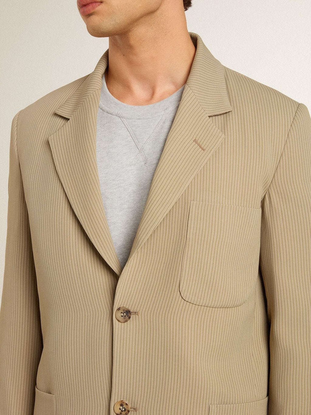 Men's beige pinstripe single-breasted jacket with an oversized fit