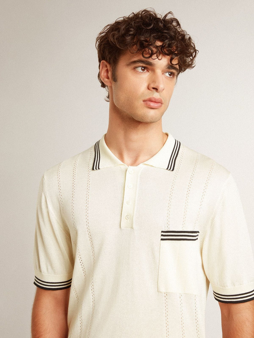 Men's worn-white knitted polo shirt with blue ribbing