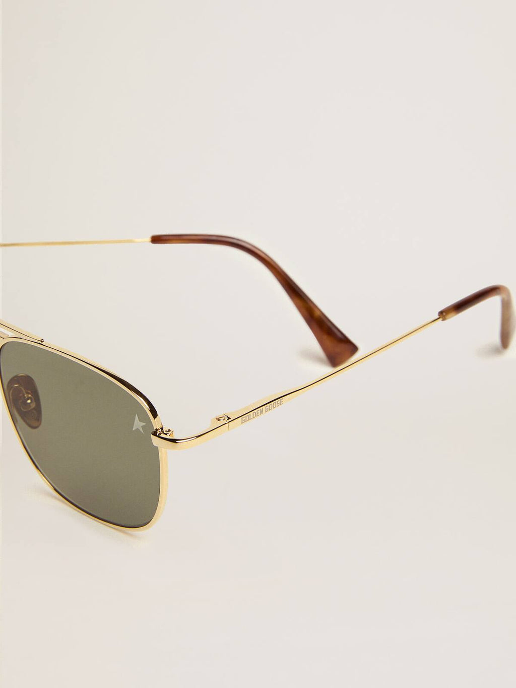 Aviator sunglasses with gold frame and green lenses