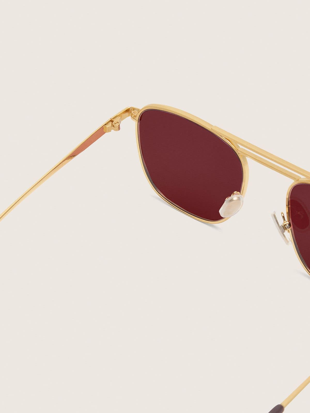Aviator style sunglasses with gold frame and green lenses