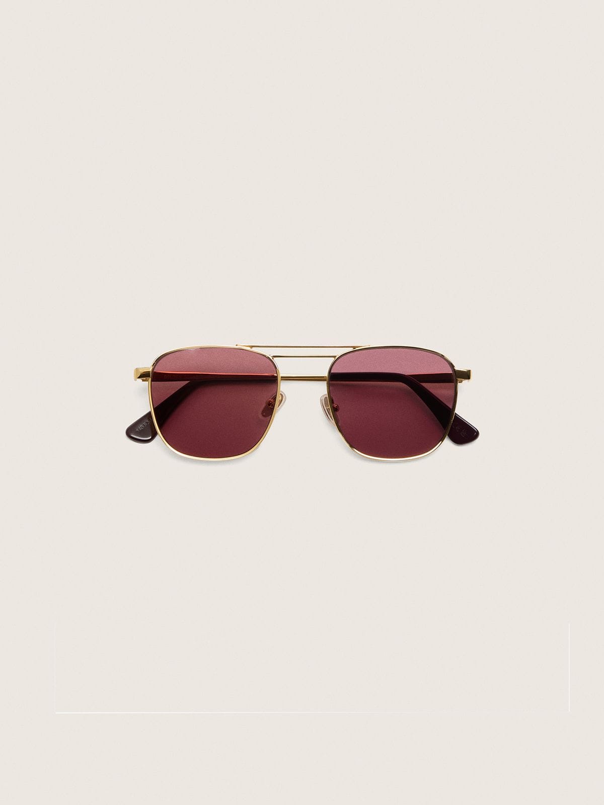 Aviator style sunglasses with gold frame and green lenses