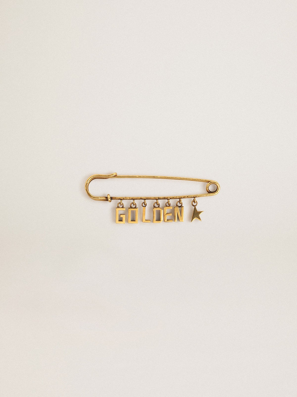 Pin in antique gold color with drop Golden lettering
