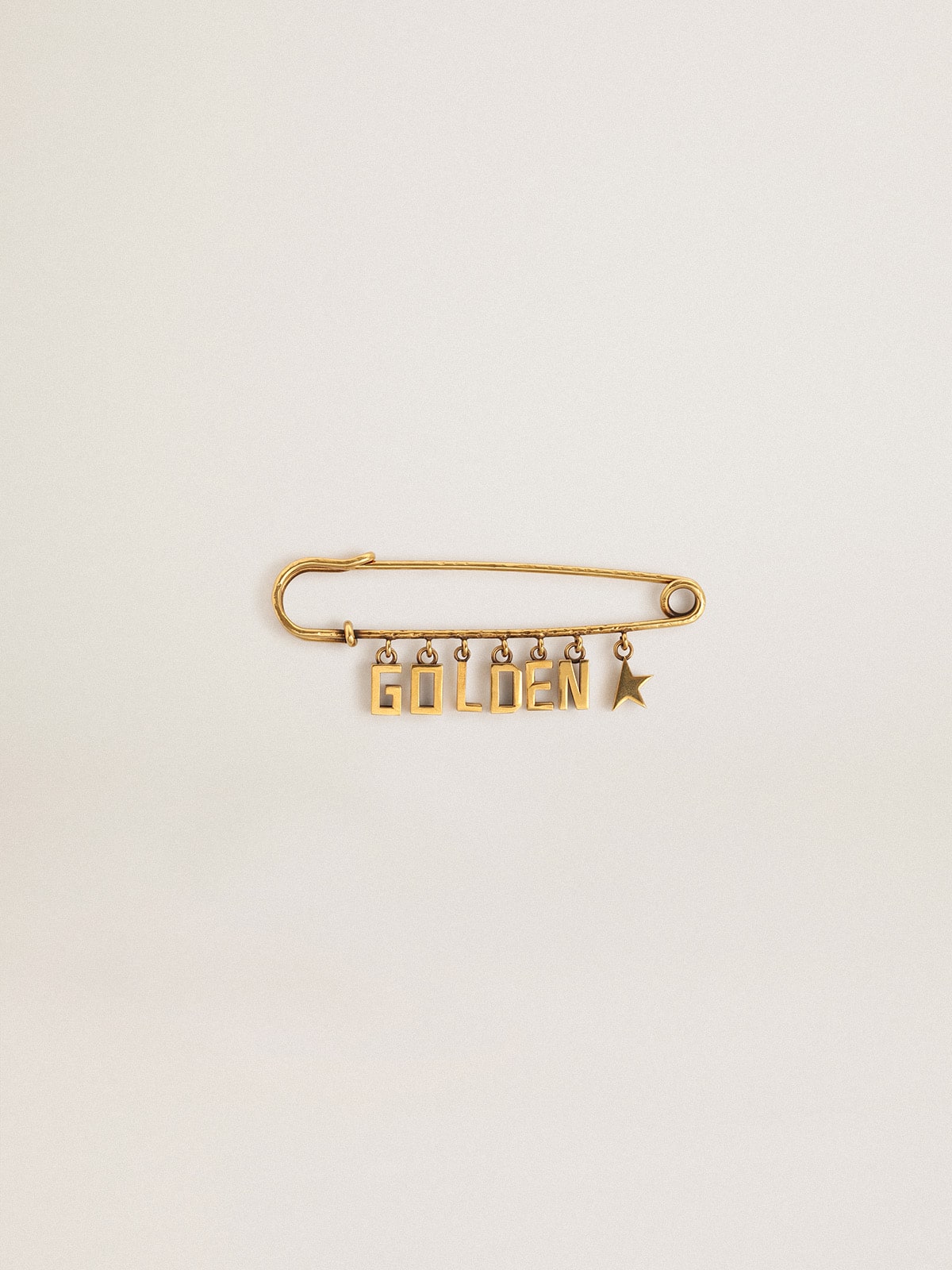 Pin in antique gold color with drop Golden lettering