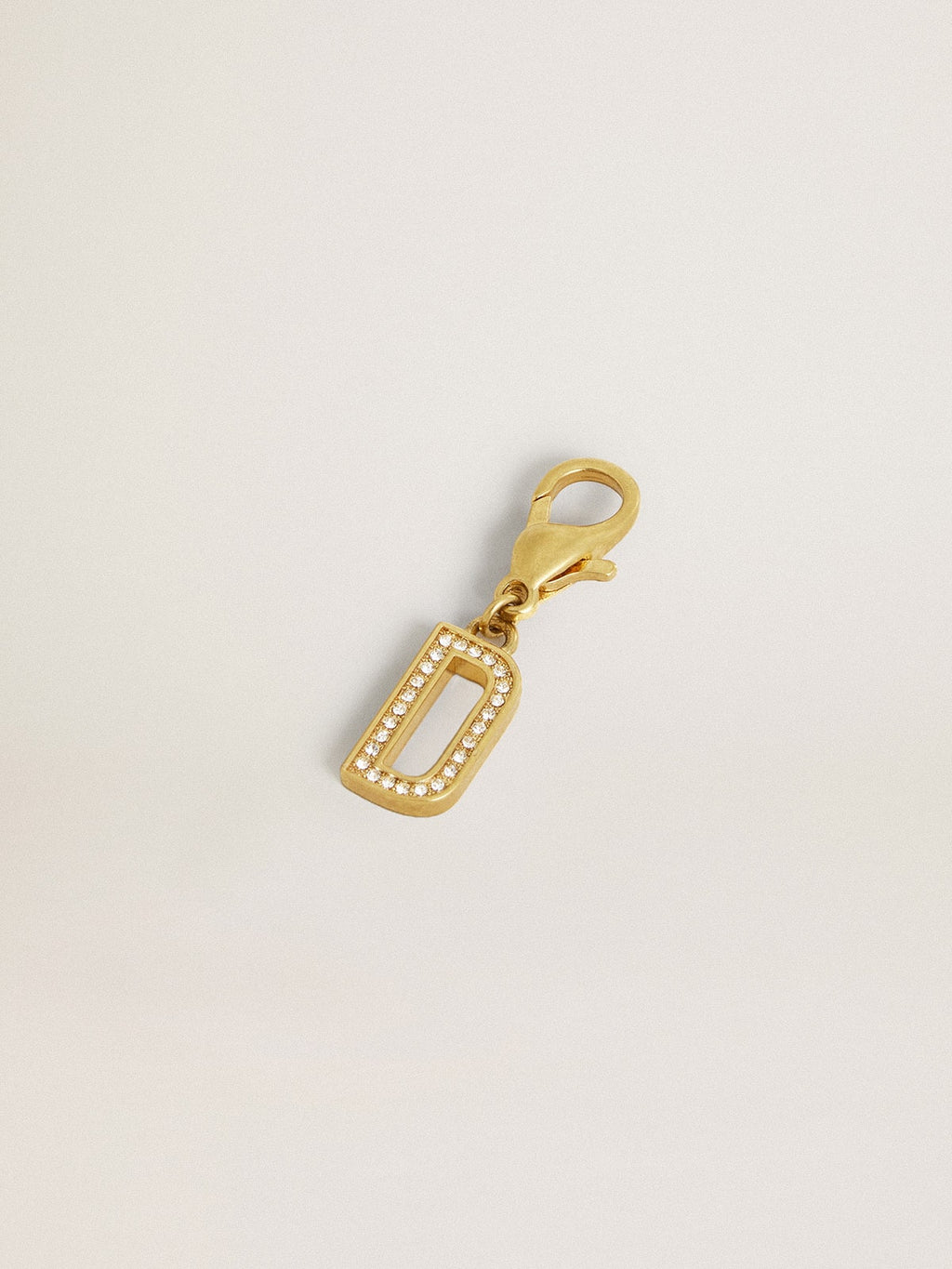 Letter D charm in gold-colored brass with crystals