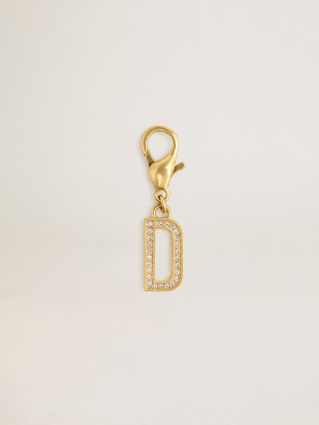 Letter D charm in gold-colored brass with crystals