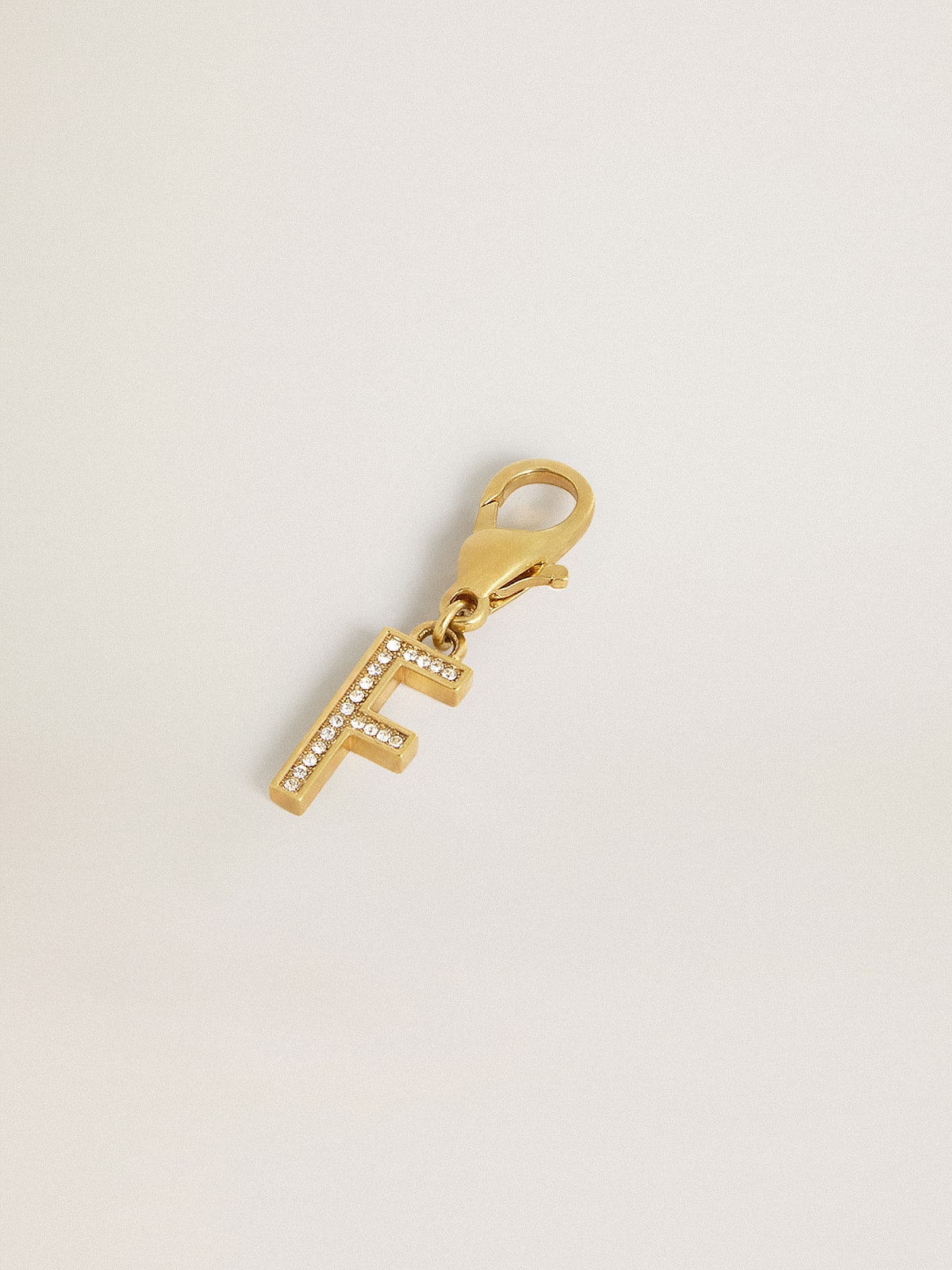 Letter F charm in gold-colored brass with crystals