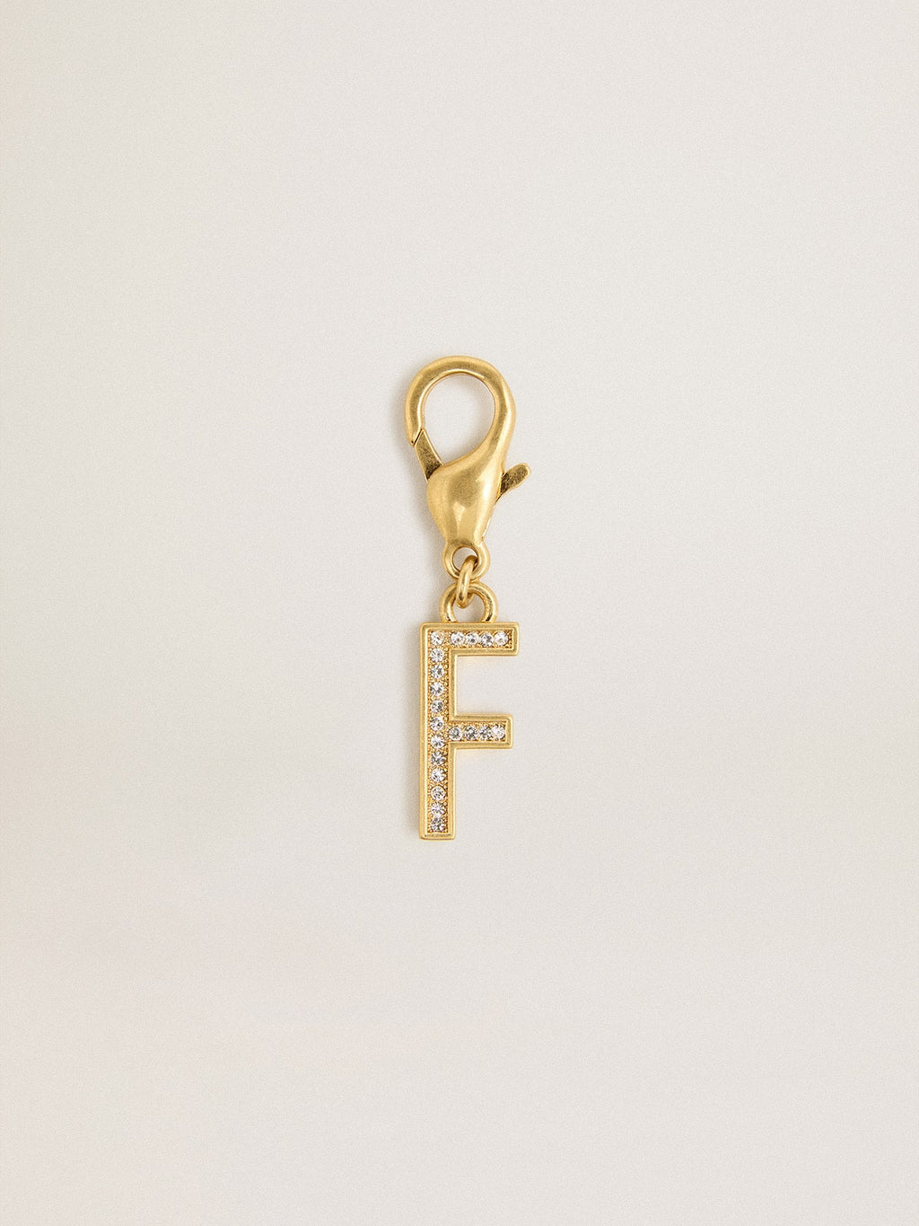 Letter F charm in gold-colored brass with crystals