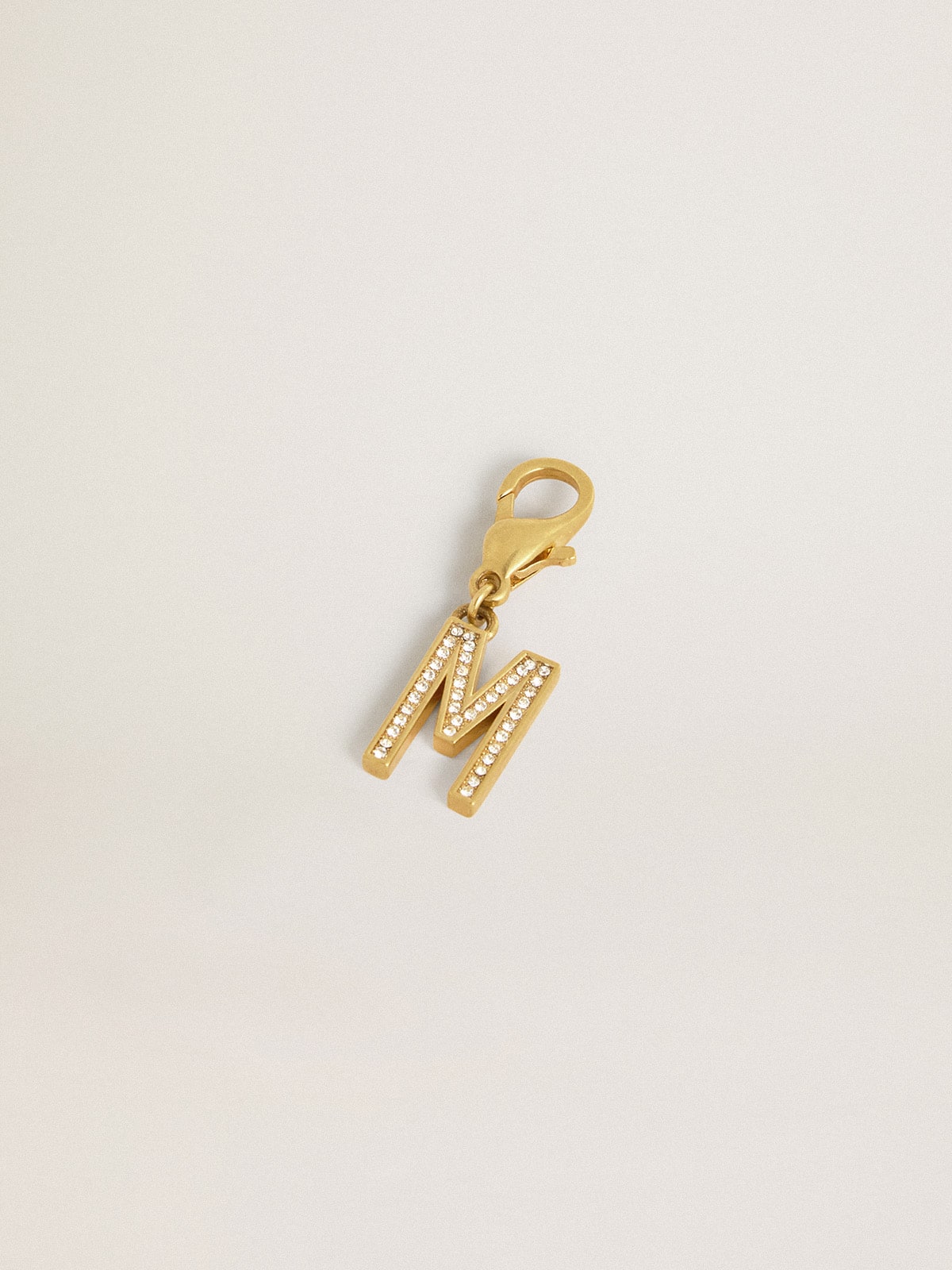 Letter M charm in gold-colored brass with crystals