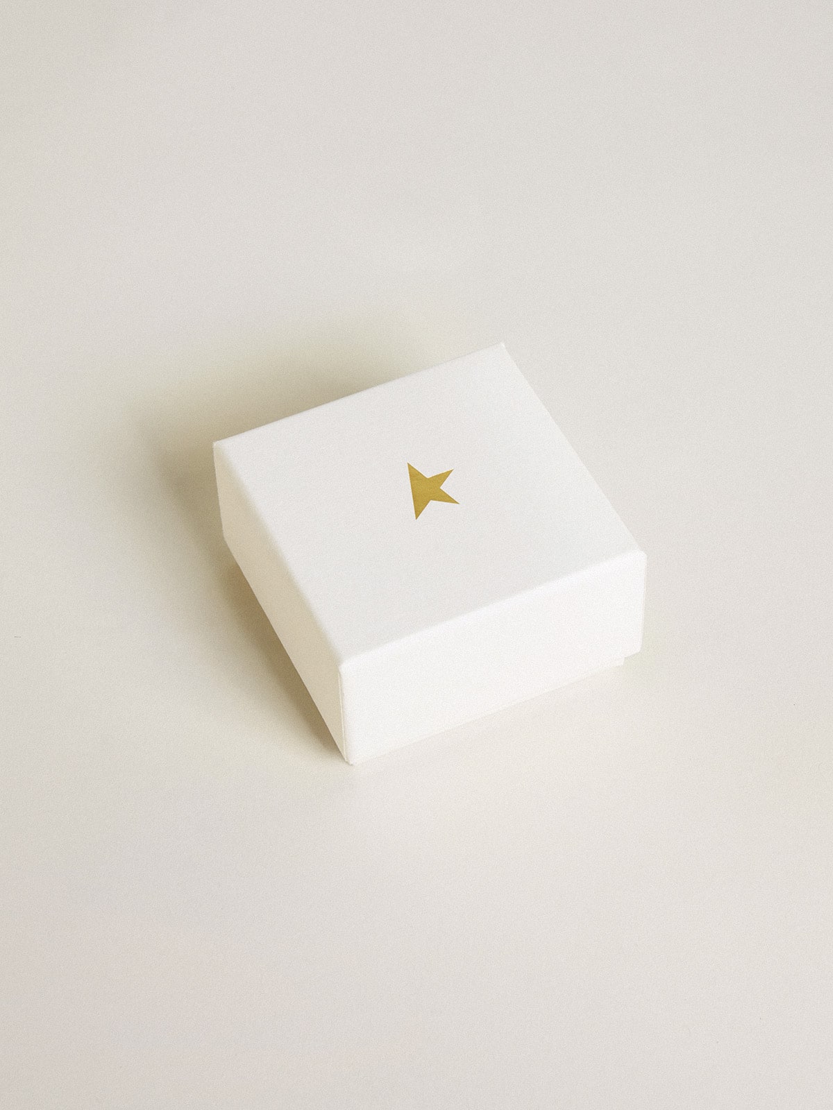 Heart-shaped charm in gold-colored brass with crystals