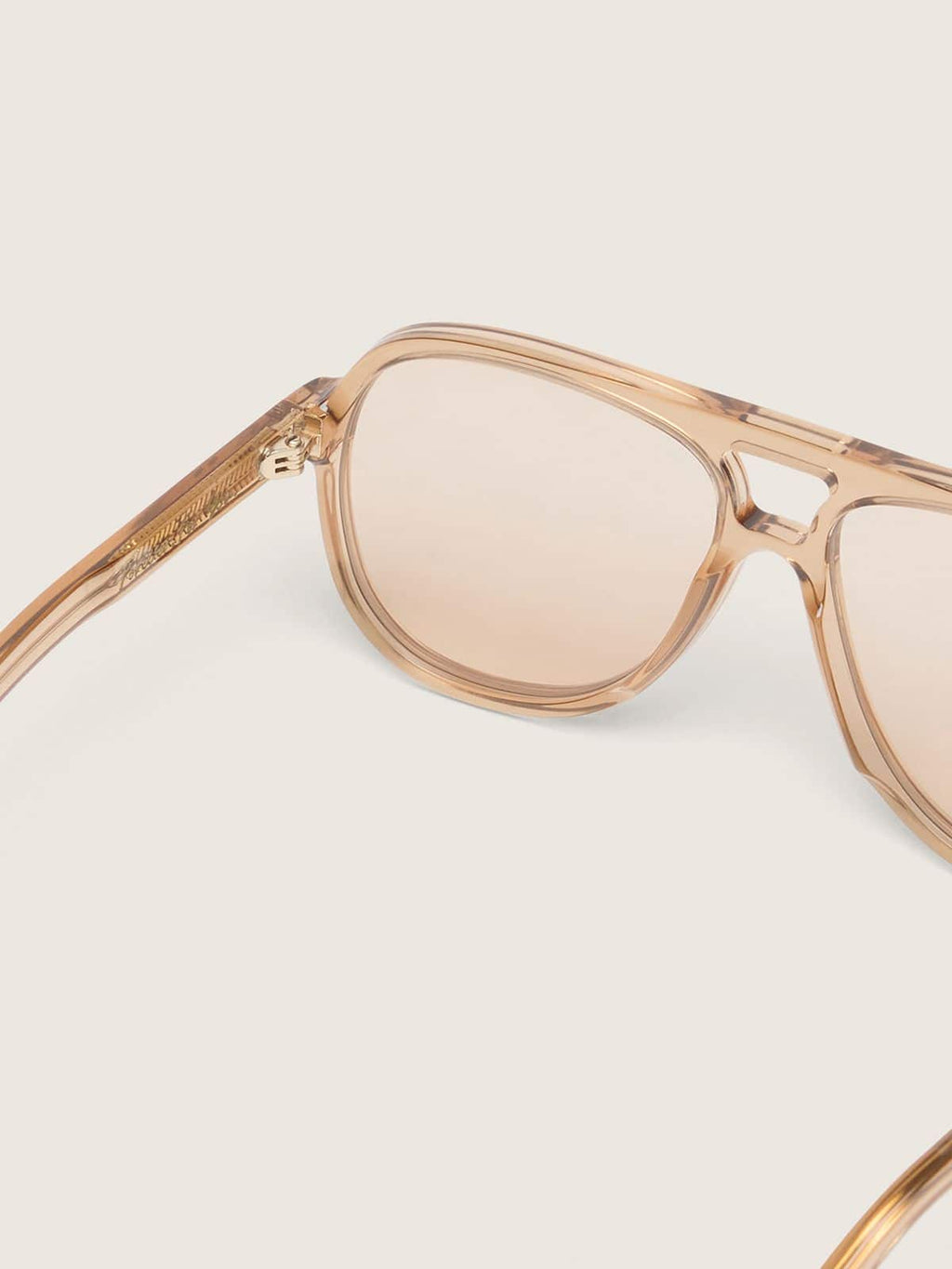 Aviator style sunglasses with honey-colored frame and lenses
