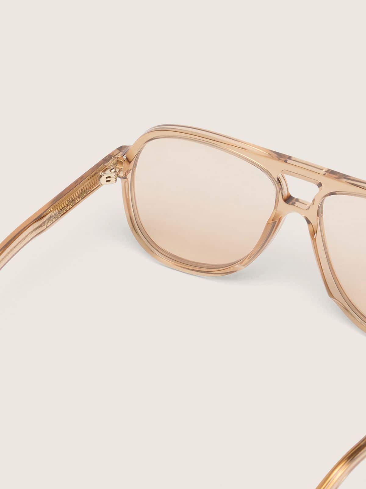 Aviator style sunglasses with honey-colored frame and lenses