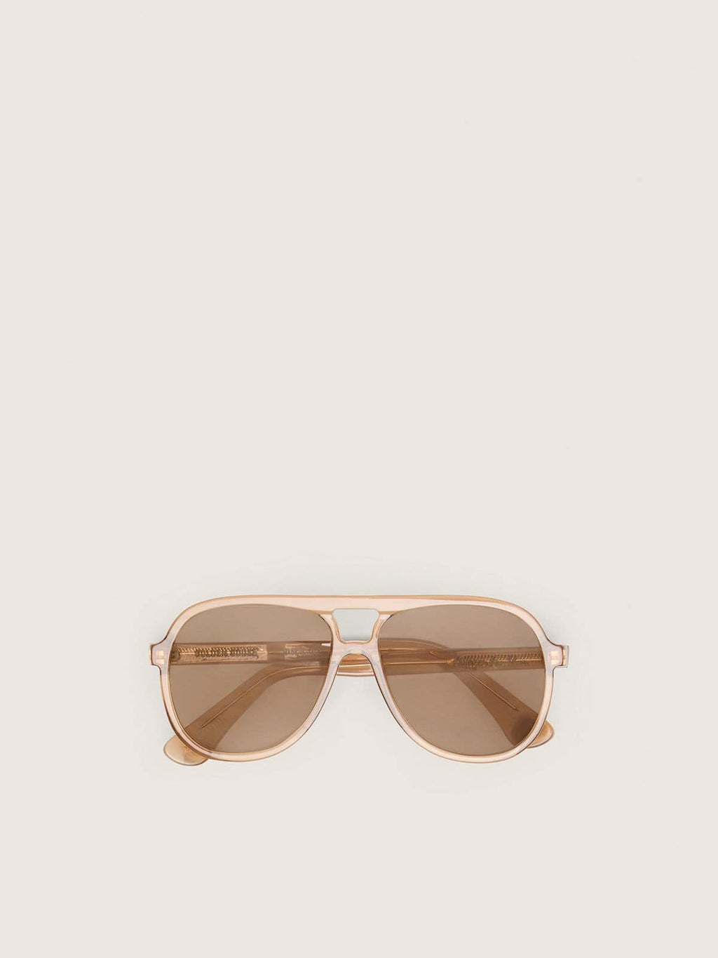 Aviator style sunglasses with honey-colored frame and lenses