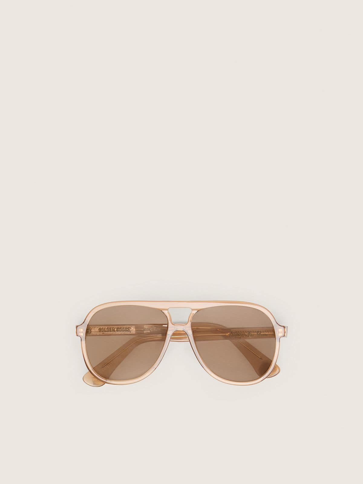 Aviator style sunglasses with honey-colored frame and lenses