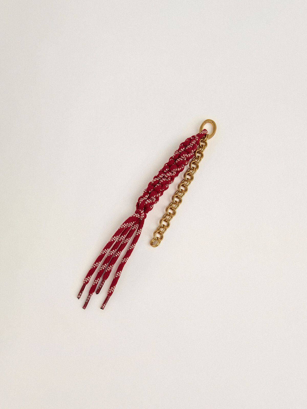 Charm with red knotted laces