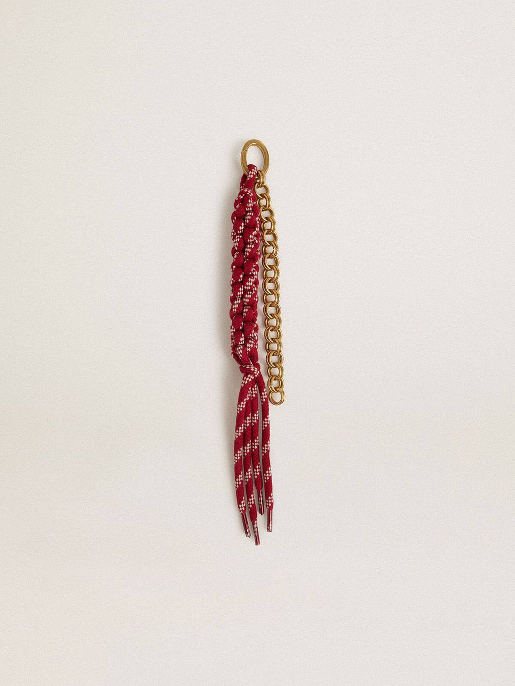 Charm with red knotted laces