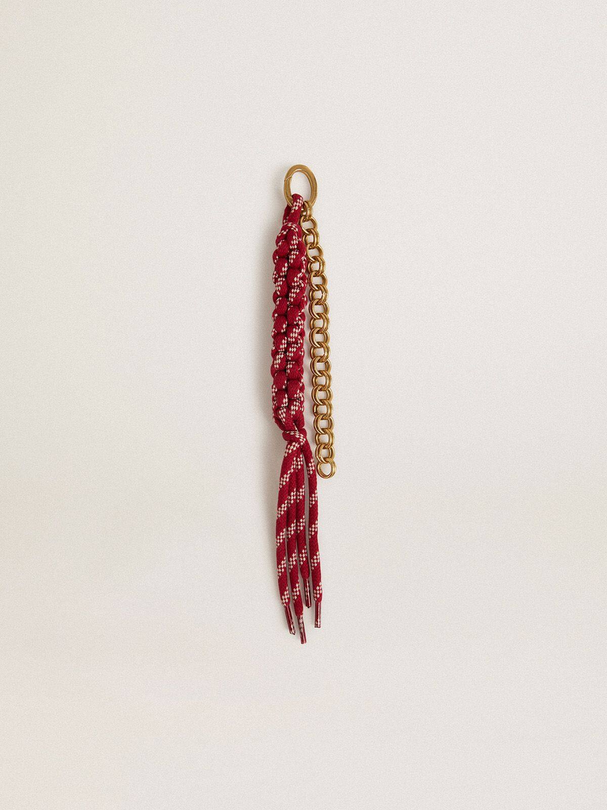 Charm with red knotted laces