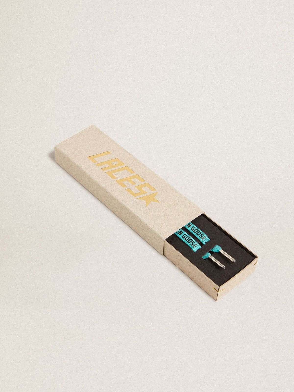 Light blue Lurex laces with contrasting black logo
