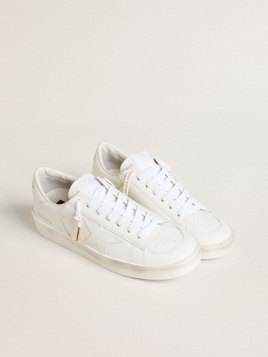 White cotton laces with contrasting gold logo