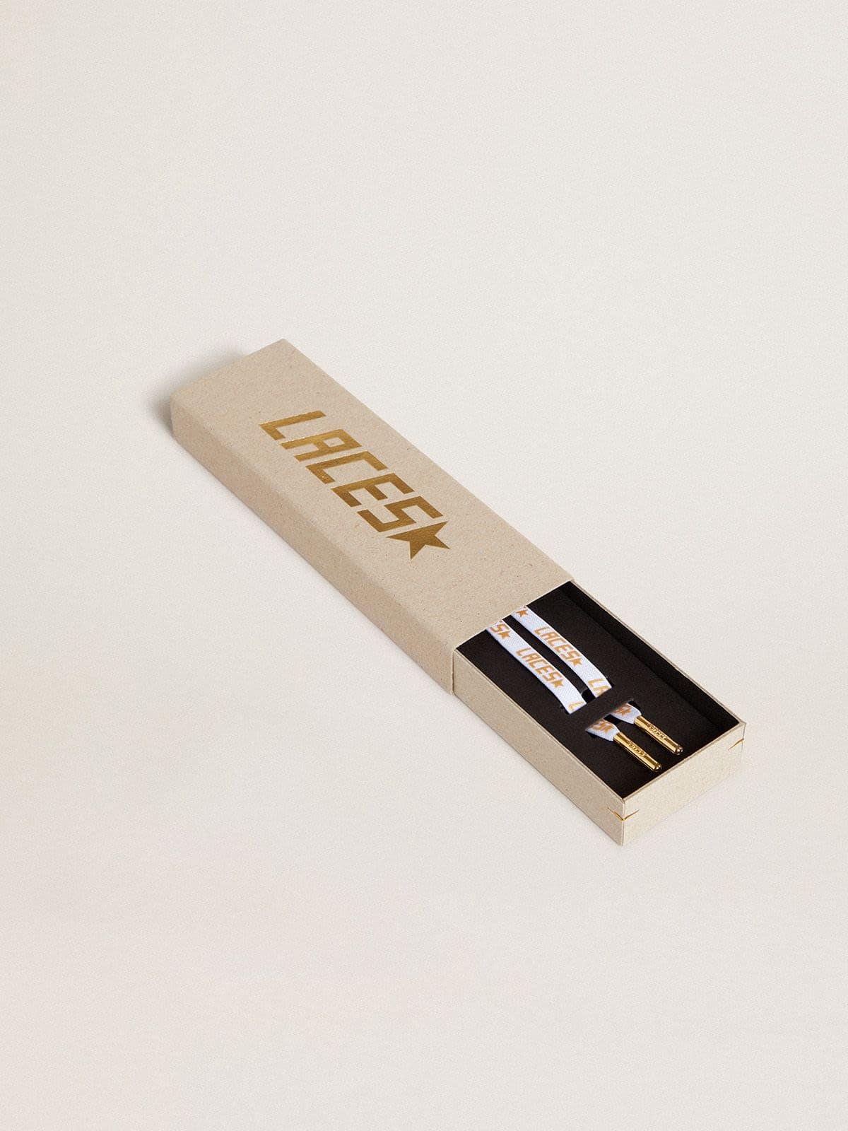 White laces with contrasting gold-colored ‘Laces’ lettering