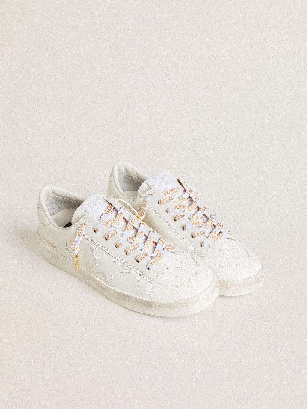 White laces with contrasting gold-colored ‘Laces’ lettering