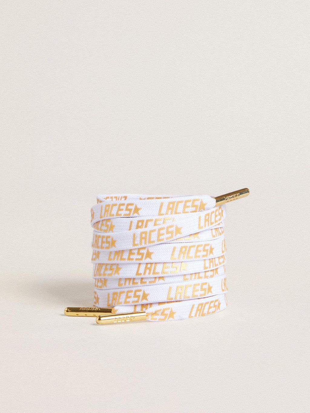 White laces with contrasting gold-colored ‘Laces’ lettering