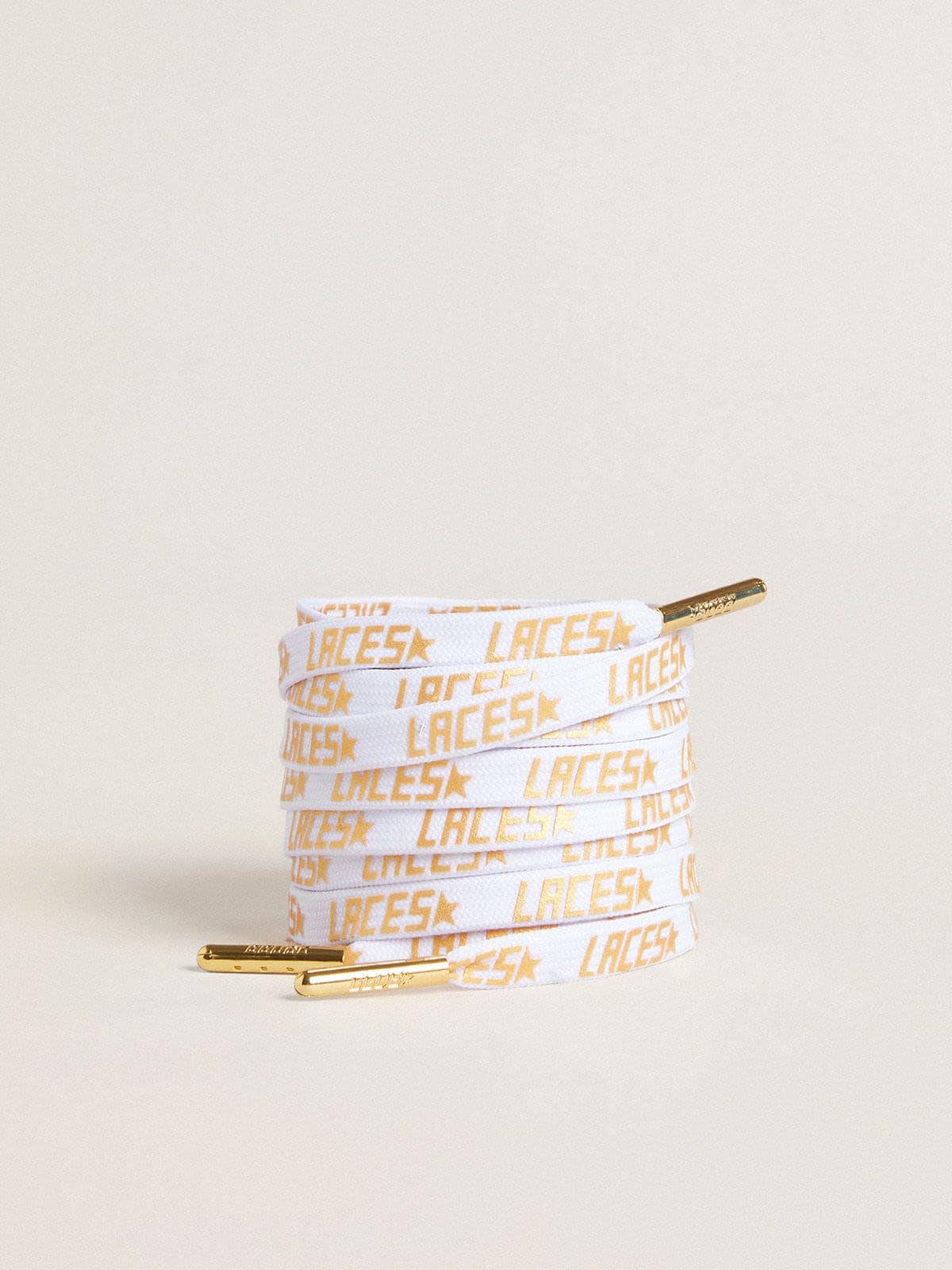 White laces with contrasting gold-colored ‘Laces’ lettering