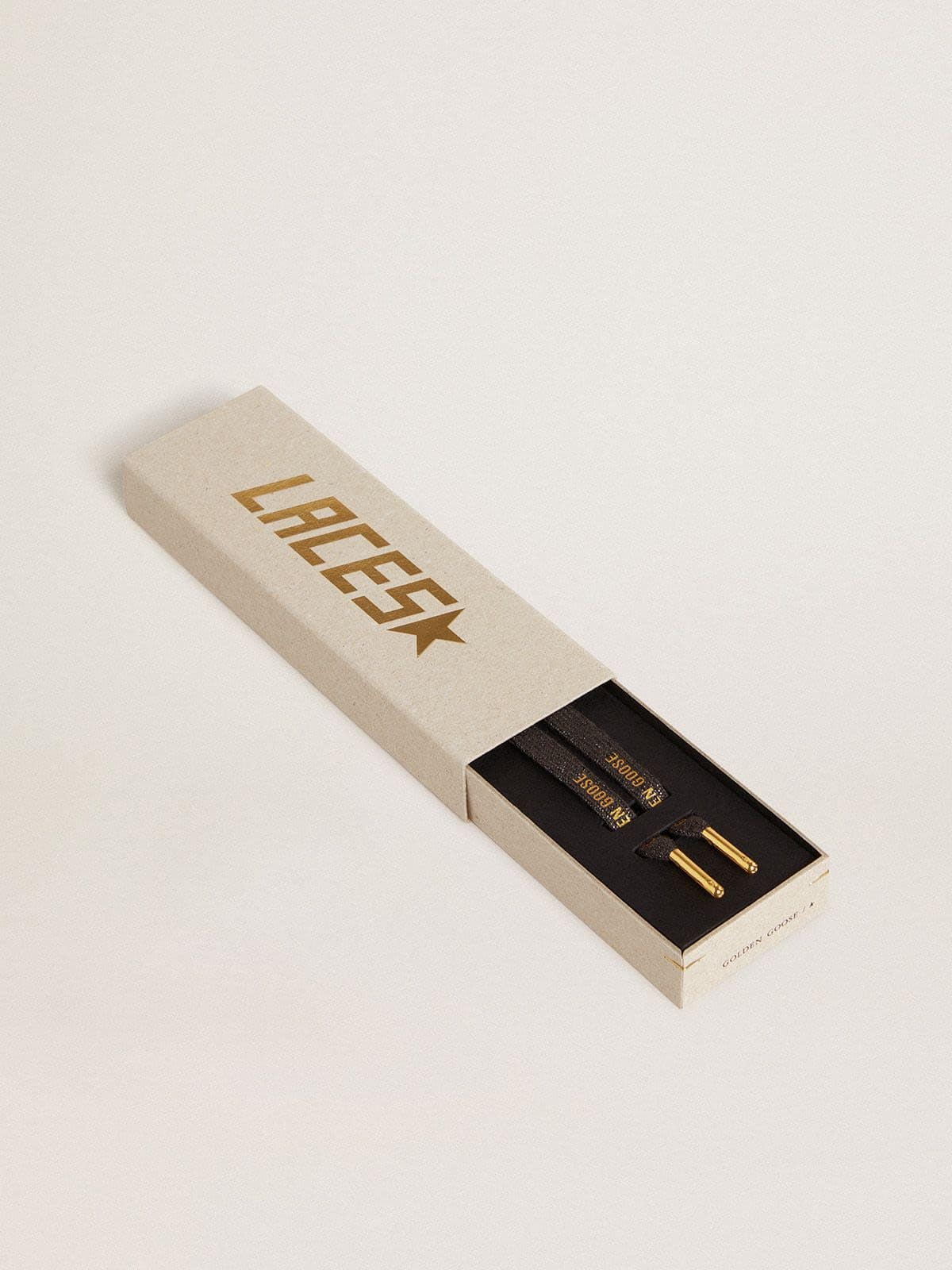 Dark gray lurex laces with contrasting gold logo