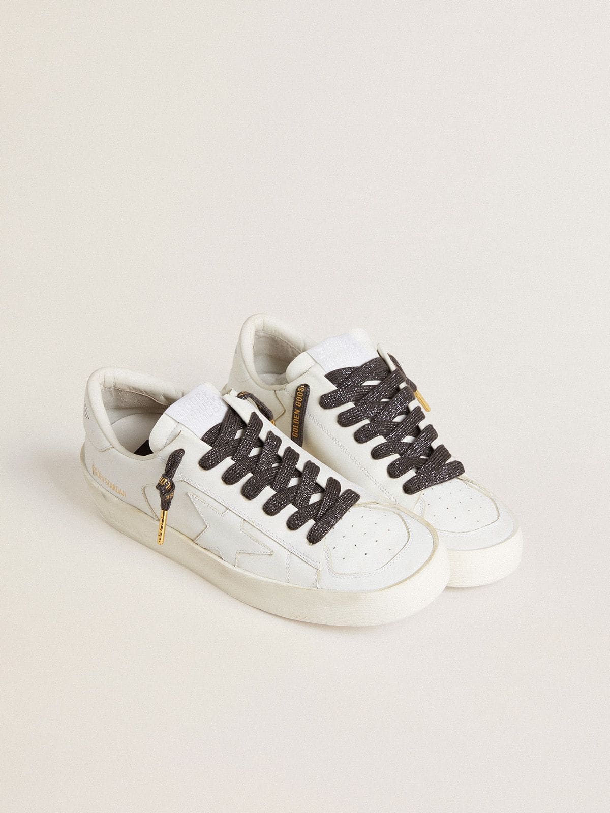 Dark gray lurex laces with contrasting gold logo