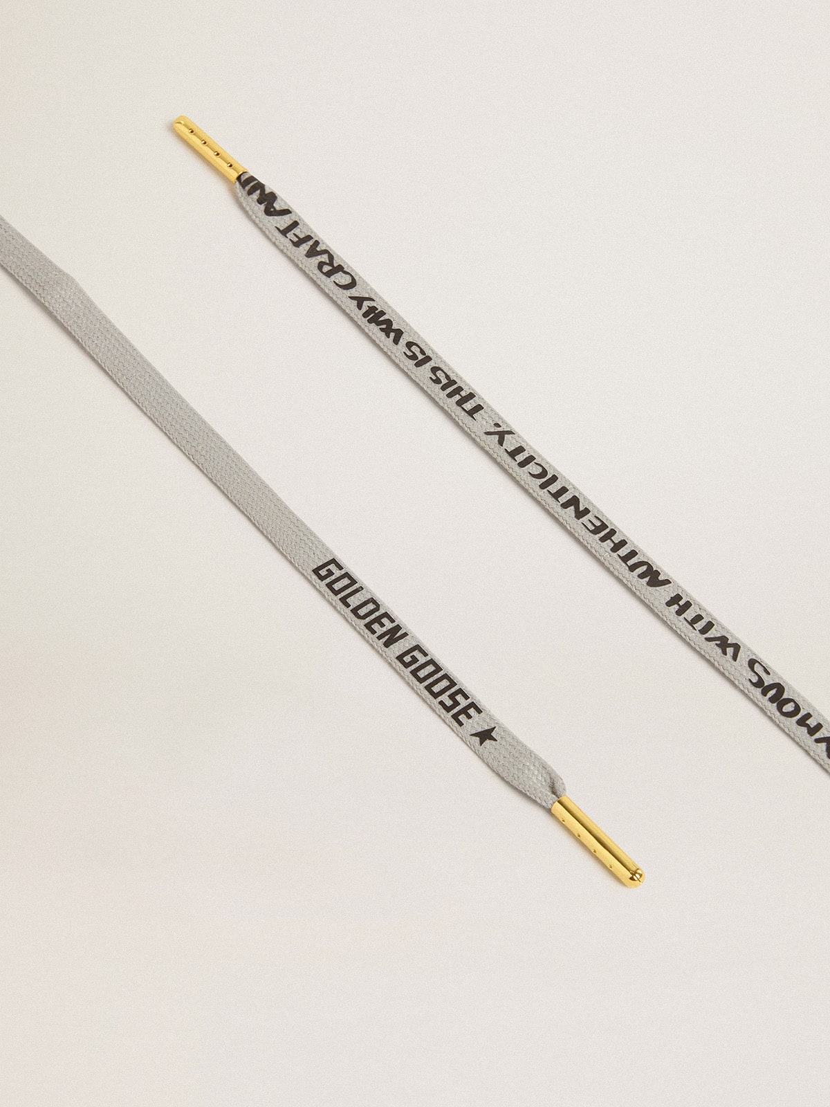 Gray cotton laces with contrasting black logo and lettering