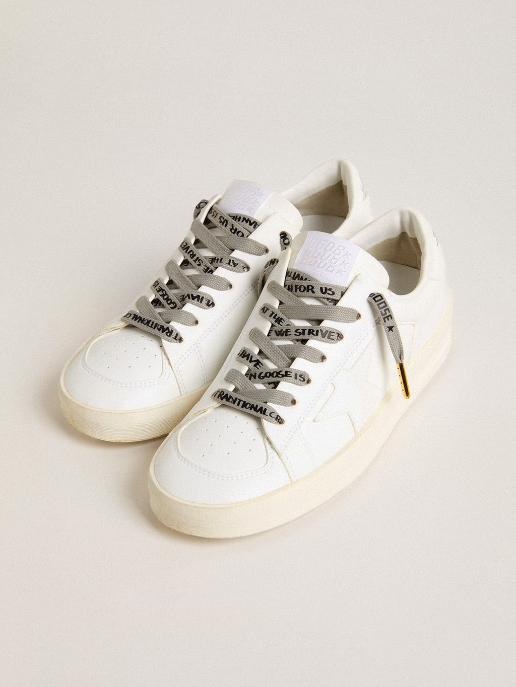 Gray cotton laces with contrasting black logo and lettering