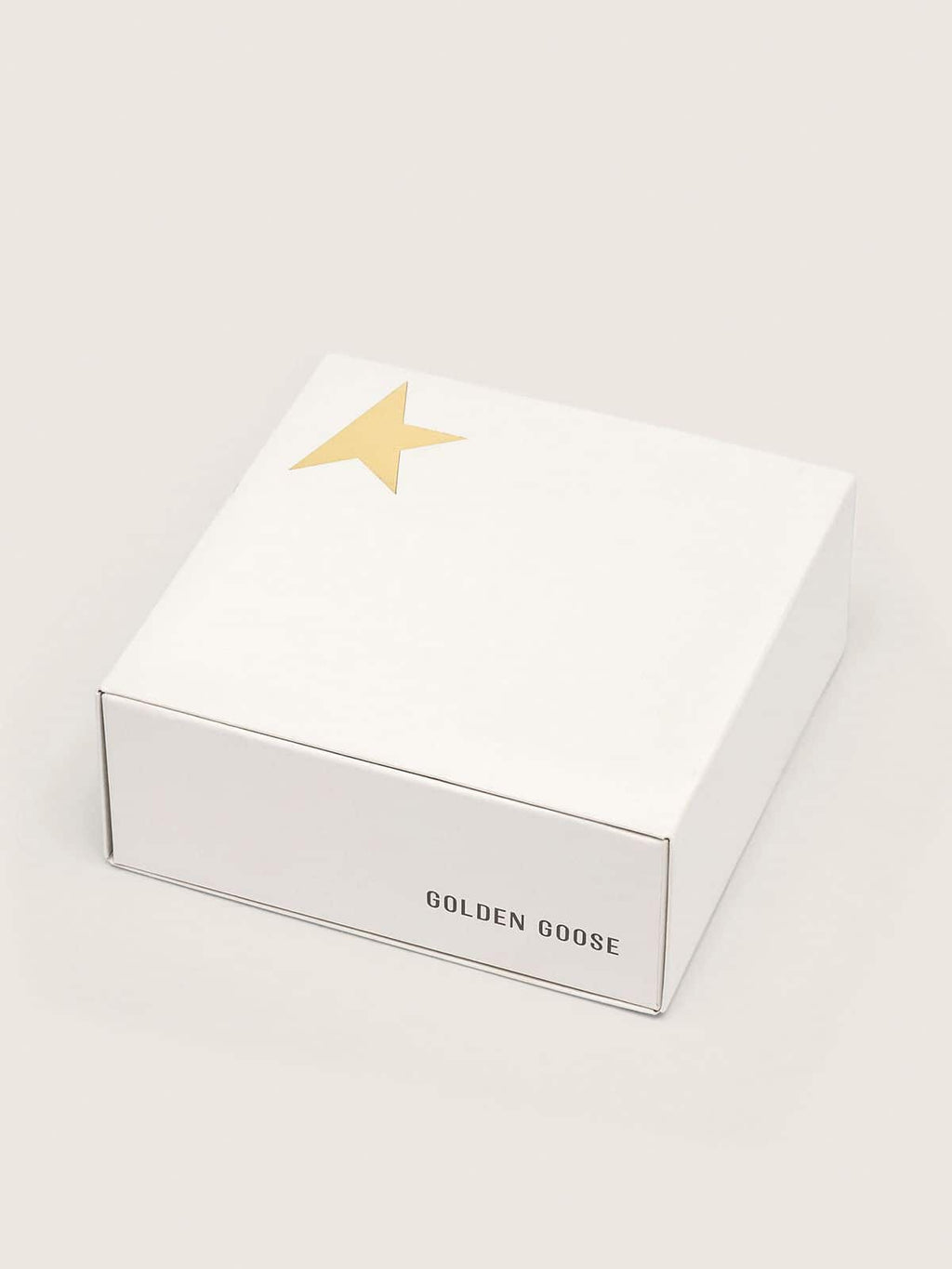 Gold-colored Lurex laces with contrasting white logo