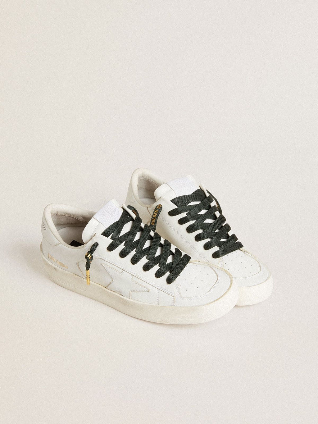 Dark green cotton laces with contrasting gold-colored logo