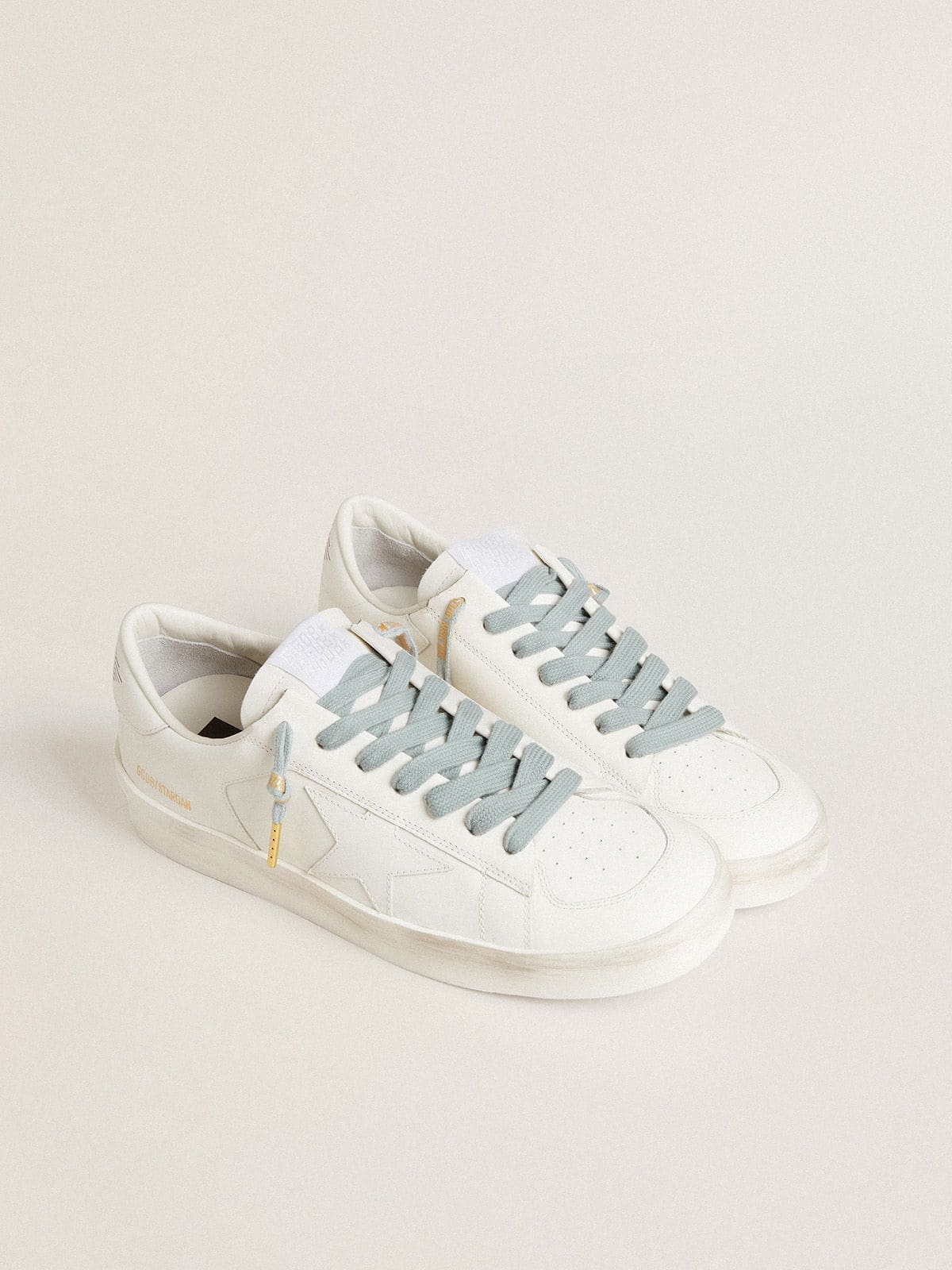 Light-blue cotton laces with contrasting gold-colored logo