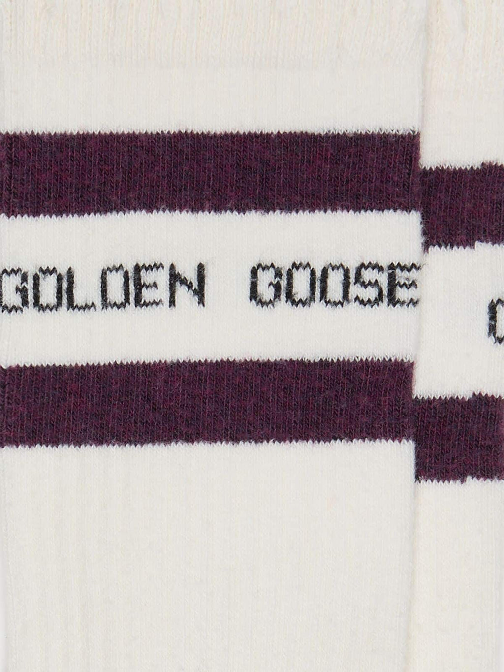 Worn-white socks with distressed details and brown stripes