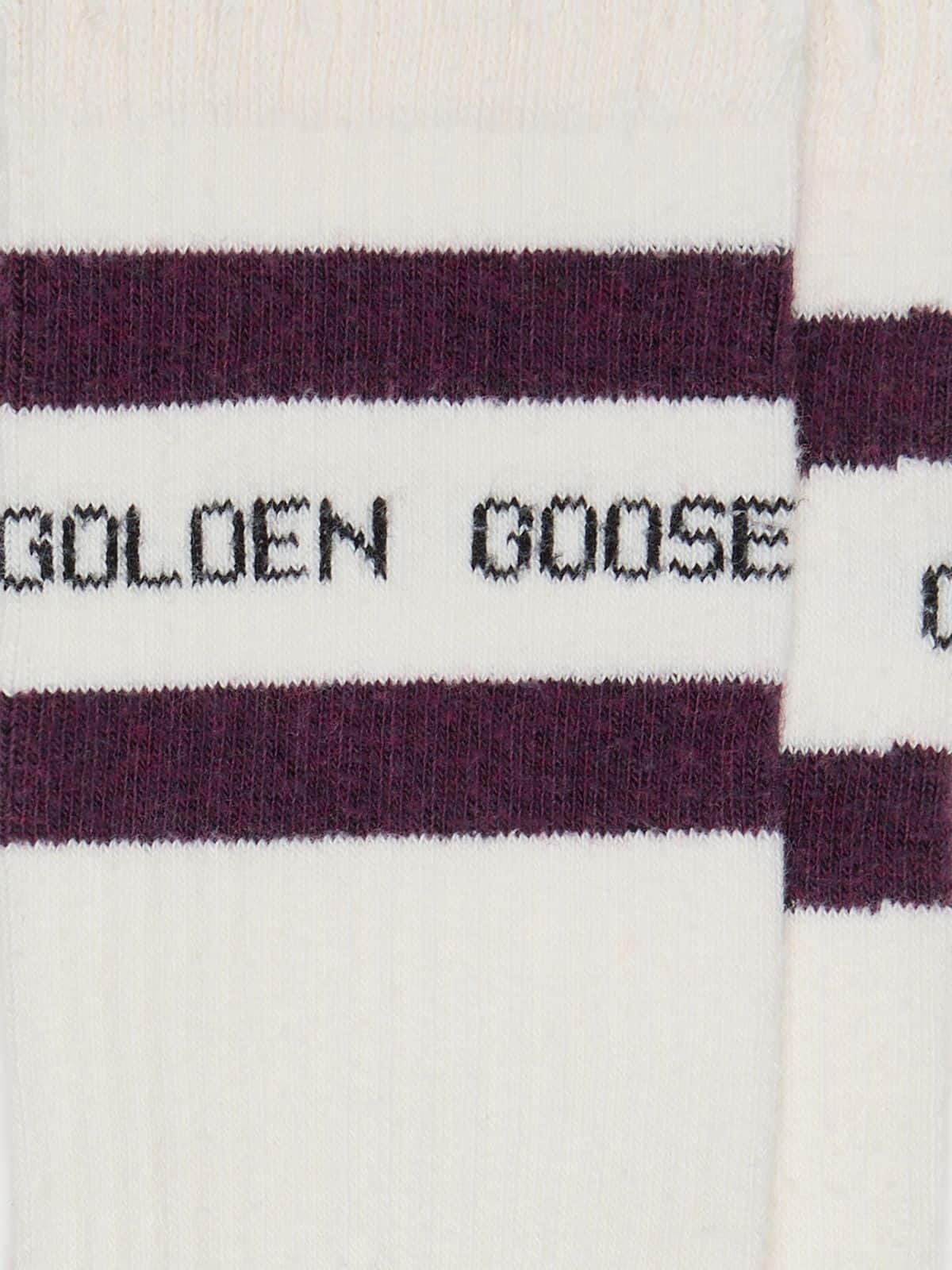 Worn-white socks with distressed details and brown stripes