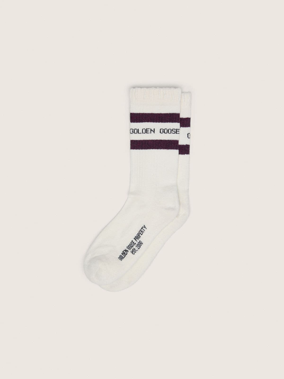 Worn-white socks with distressed details and brown stripes
