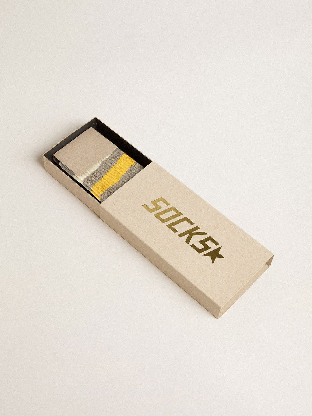 Gray socks with distressed details and yellow and white stripes